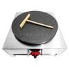 The Crepe Machine Gas Stainless Steel FR-42 features a sleek black cooking surface, stainless steel accents, and comes with a wooden spreader on top.