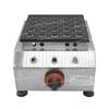 The Dorayaki Mini 25 Holes Machine Gas FNP-693 is a stainless steel takoyaki maker with a black cooking plate featuring multiple round molds and a red heat control knob, ensuring precision cooking for delicious treats.
